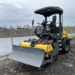 Yellow and gray Wacker Neuson RC50 soil compactor with a blade attachment.
