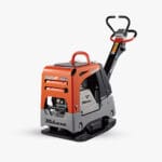 A compact orange and gray vibratory plate compactor with the brand name "Mikasa" visible on its side. The machine features a handle for maneuvering and a sturdy base designed for compacting soil, asphalt, or gravel on construction sites.