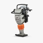A soil compactor or tamping rammer with a gray and black body, featuring a red coiled spring suspension system and a rectangular base plate for compacting soil. The machine is designed for use in construction or landscaping to compress earth and create stable surfaces.