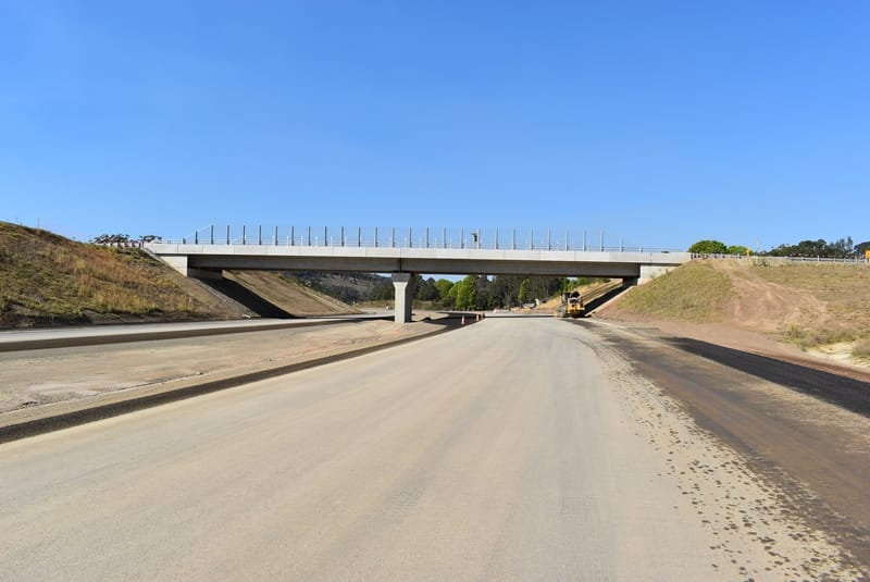 Nam10031 - Conplant Pty Ltd - Conplant Pty Ltd A newly constructed overpass bridge showcases defined capability above a wide, empty road.