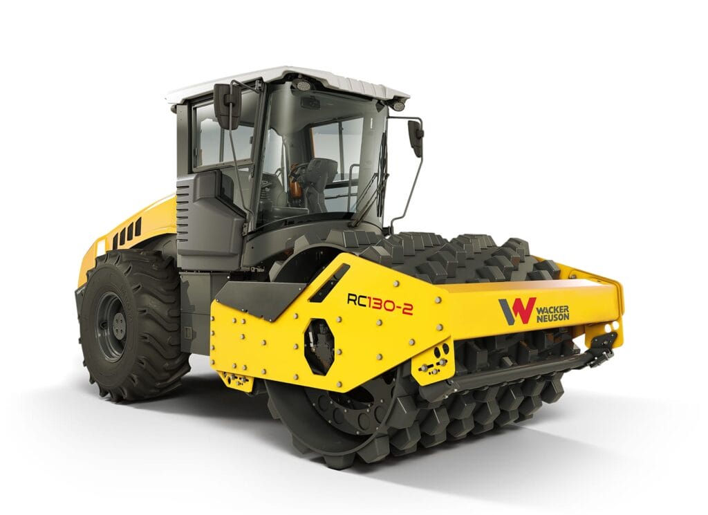 A yellow and black road roller with a spiked front drum is labeled "RC130-2" and "Wacker Neuson." Part of the Series RC-2, it features a driver's cabin and large rear tires, designed for compacting surfaces in construction.