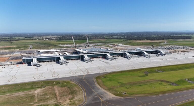 WSI_airport_terminal_2025-edit--2200x1200 - Conplant Pty Ltd - Conplant Pty Ltd Aerial view of a modern airport terminal under construction with measurable compaction underway.