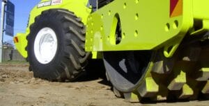 clay compaction blog - Conplant Pty Ltd Close-up of a bright yellow construction vehicle compacting clay soil on a dirt surface.