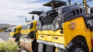 Three yellow mini roller compactors parked outdoors, ideal for residential compaction tasks.