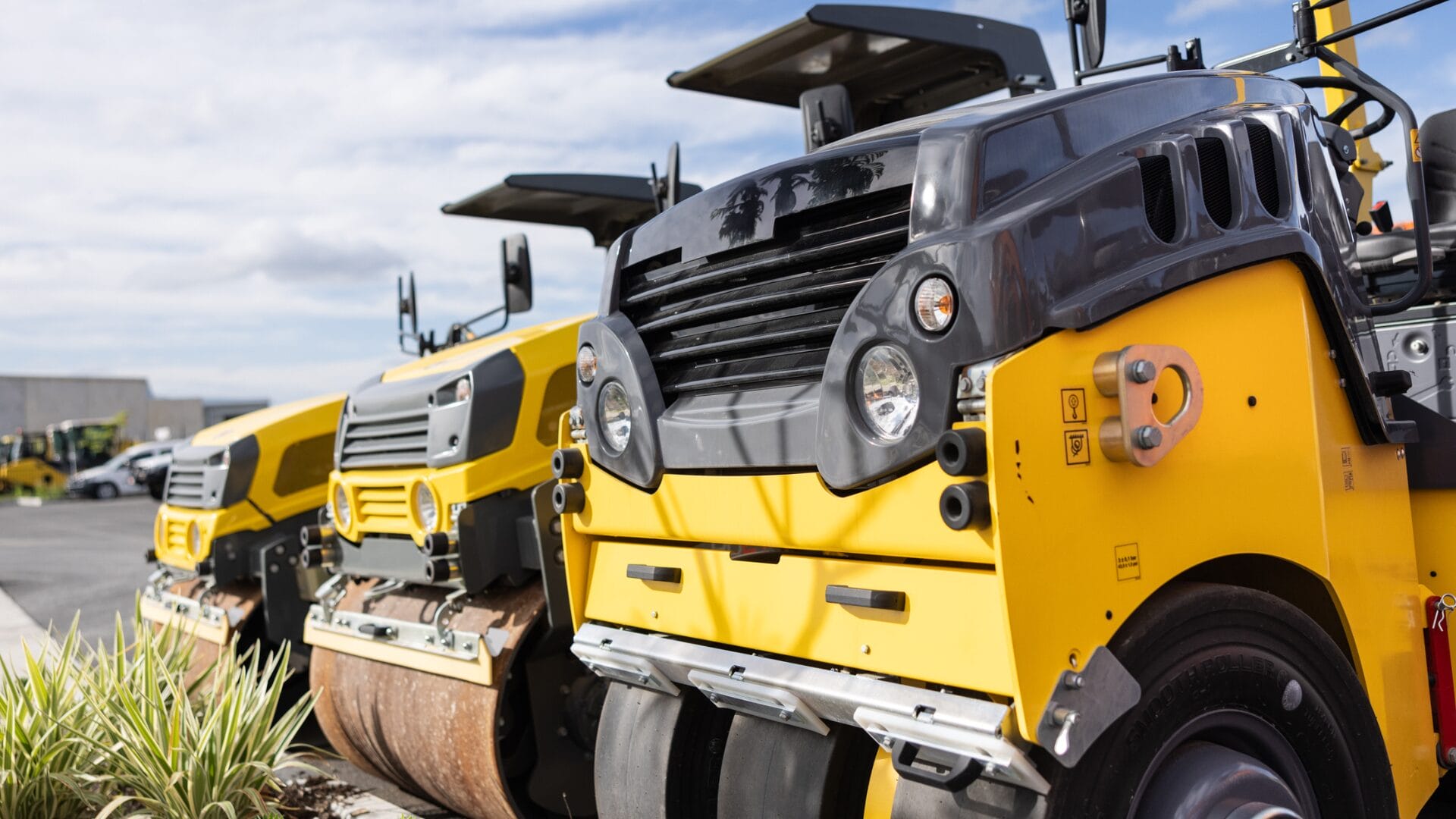 Three yellow mini roller compactors parked outdoors, ideal for residential compaction tasks.