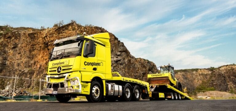 Yellow Conplant truck and loader at a quarry, showcasing Queensland construction capacity.