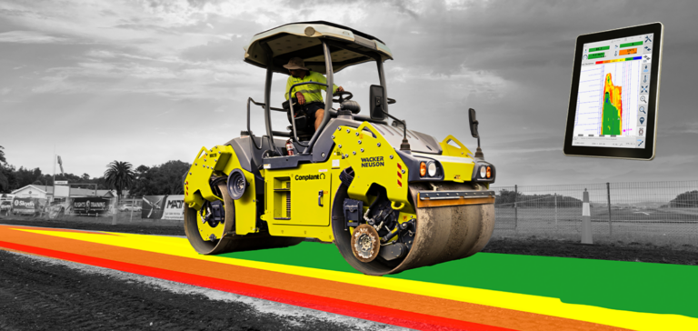 Yellow road roller on a construction site paving a multicolored lane (red, orange, yellow, green) with a floating tablet showing a color-coded pavement chart, left-to-right scenery in grayscale.